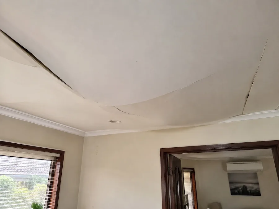 Collapsed ceiling caused by termite damage with large sagging sections inside a Perth home