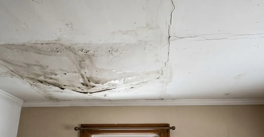 Water-damaged ceiling with sagging plaster and visible cracking, a common sign of leaking roofs in Perth homes.