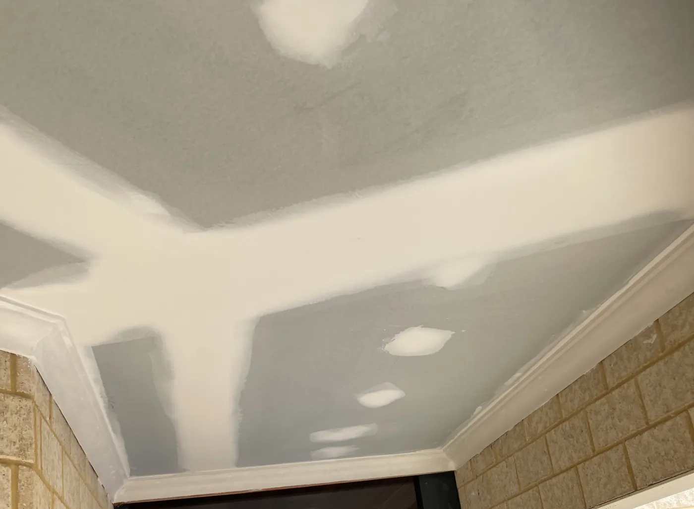 Lined ceiling with flushed joins between two brick walls in a Morley home