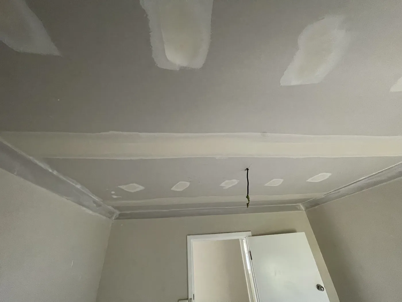 Close view of compound on the ceiling seams beside the cornice in South Perth