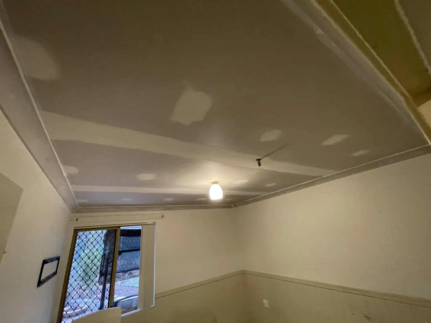 Flushed plasterboard ceiling and cornice in a Wanneroo room