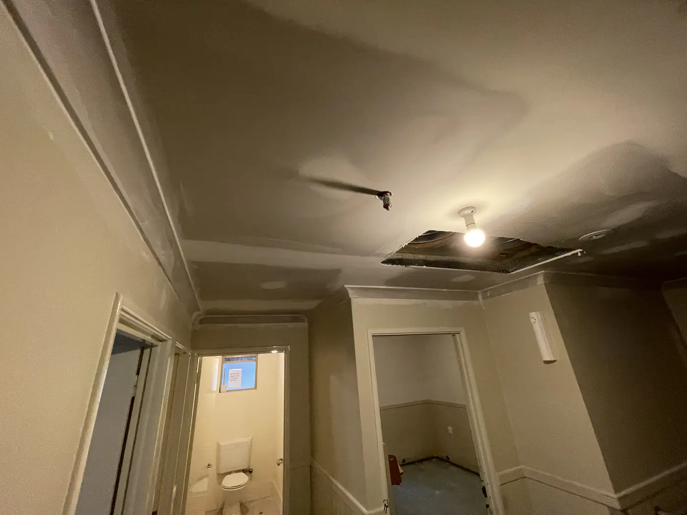 Ceiling joins being finished around a light point and bulkhead in Wanneroo