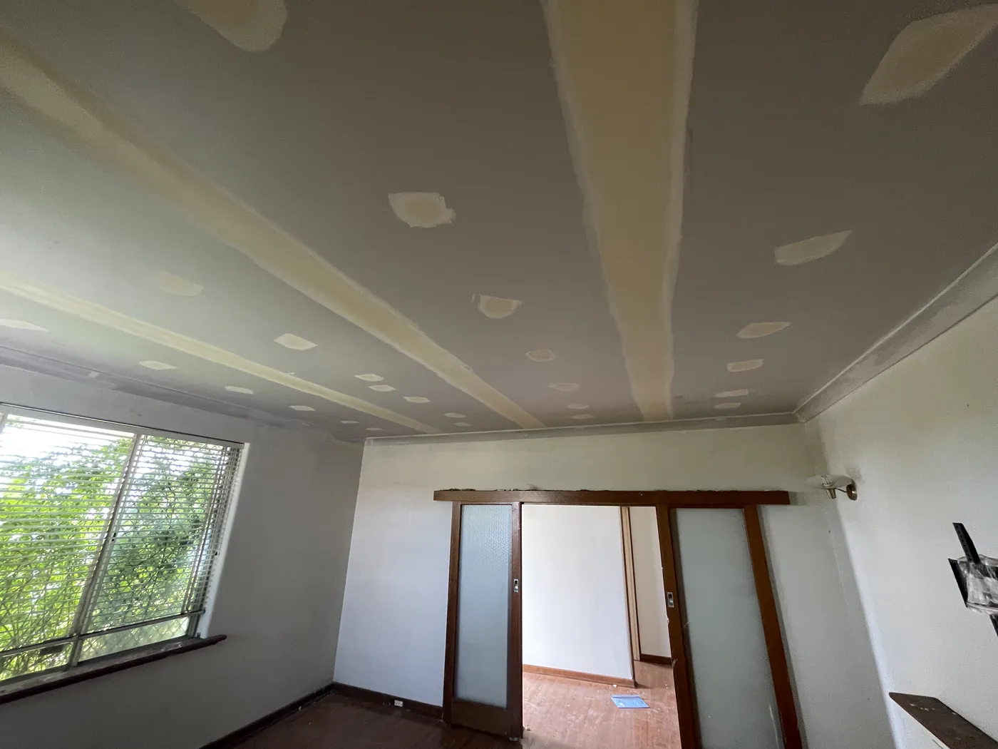 Same Scarborough room from the other side, with timber-framed doors under the new ceiling