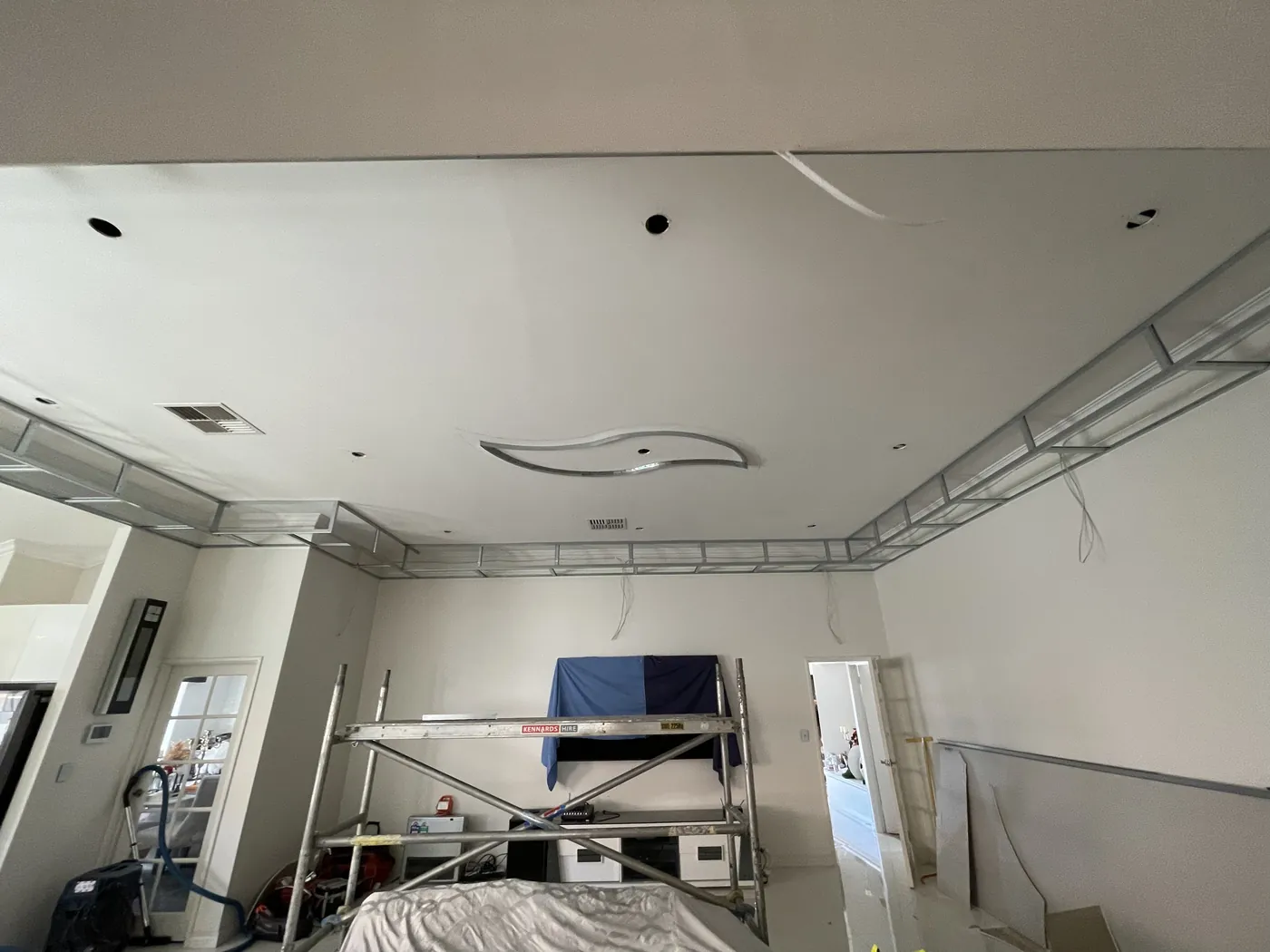Steel framing for a stepped ceiling edge going up in a large Clarkson living room
