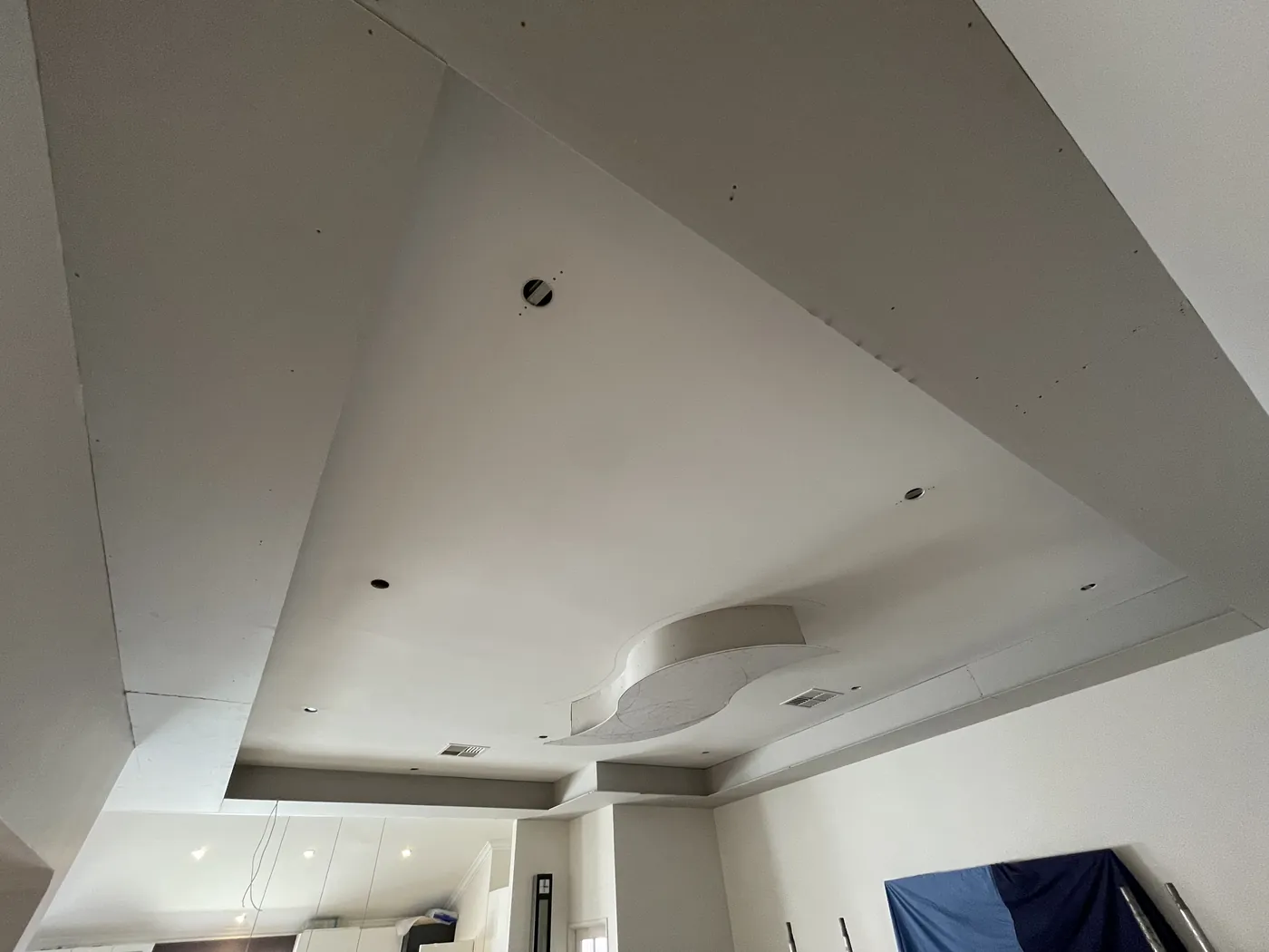 New stepped plasterboard ceiling with recessed features in a Clarkson living room