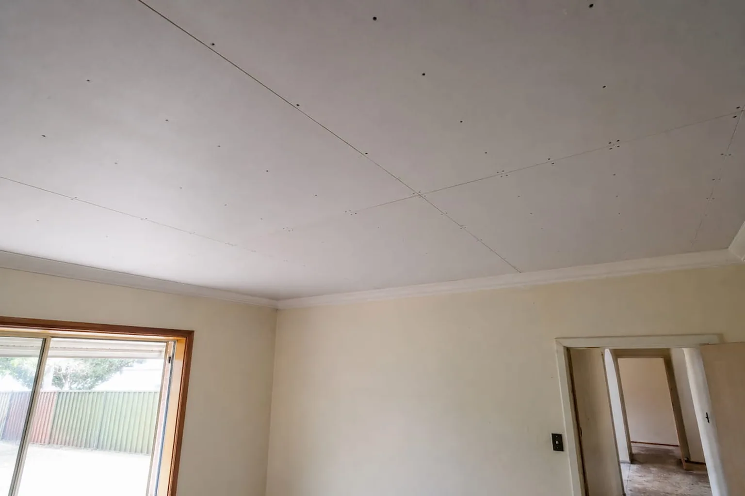 Fresh plasterboard resheeted over a plasterglass ceiling in a Perth home