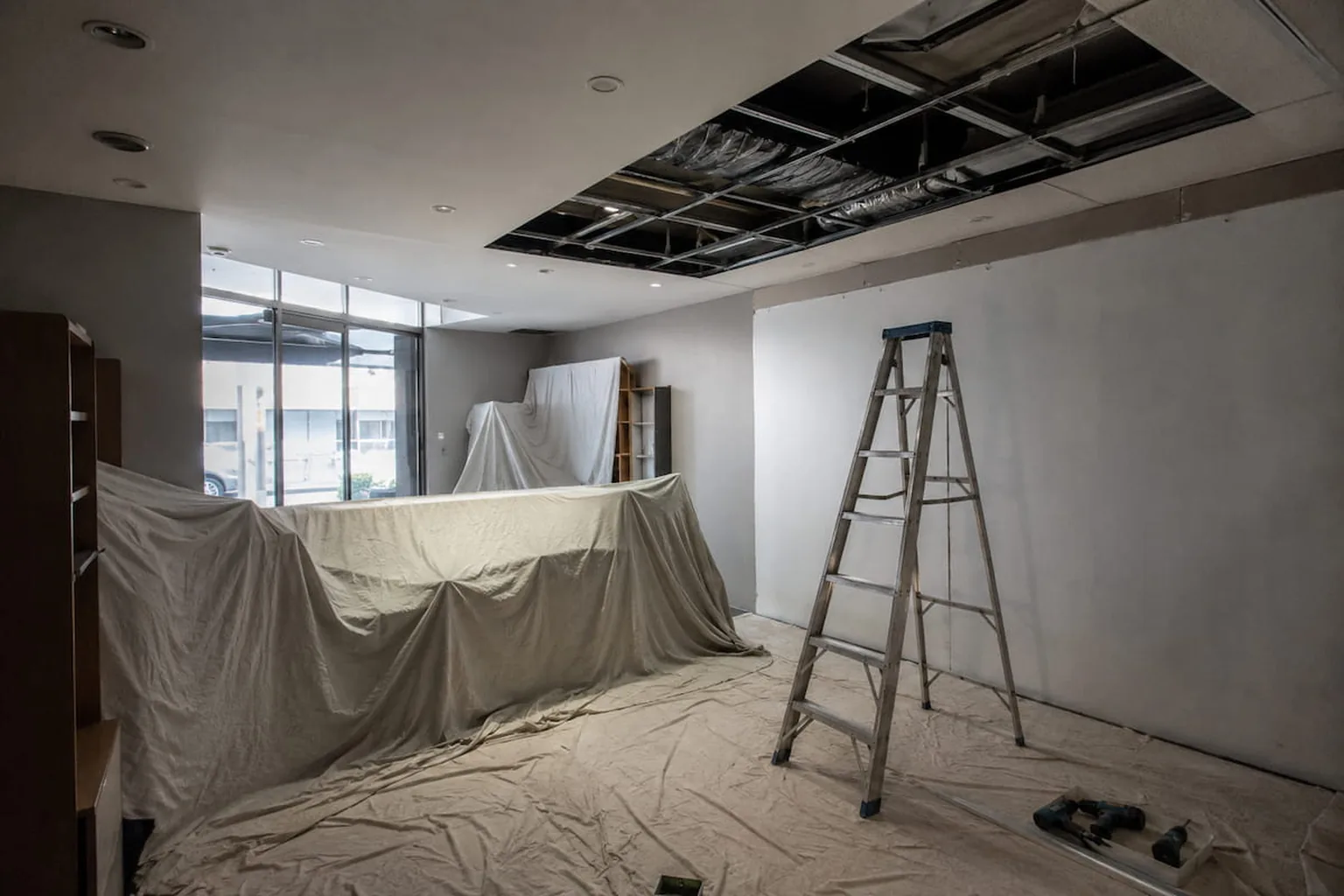 A commercial ceiling repair under way with the space sheeted off and access set up