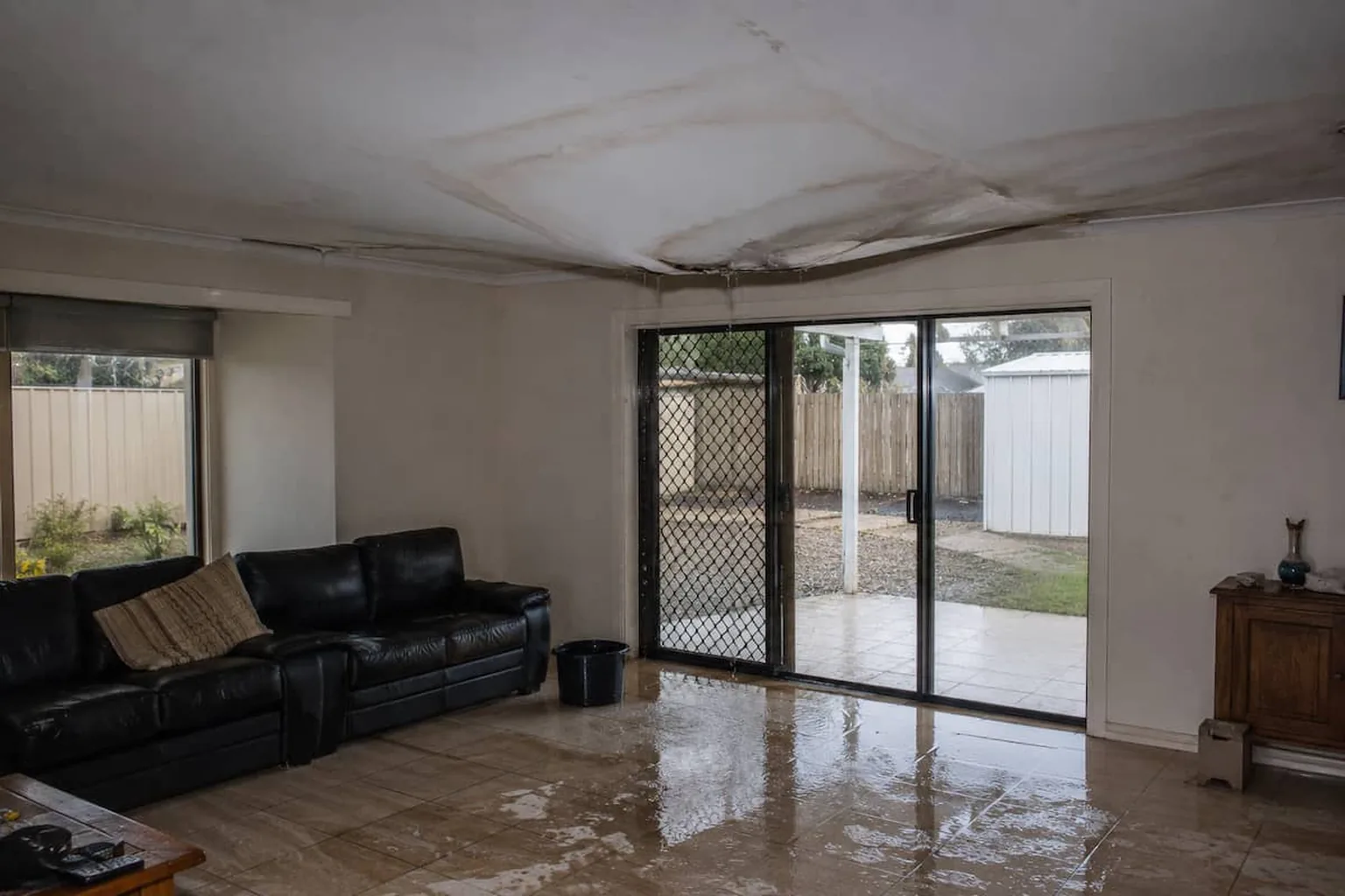A ceiling sagging badly and cracked open after storm water got into the roof