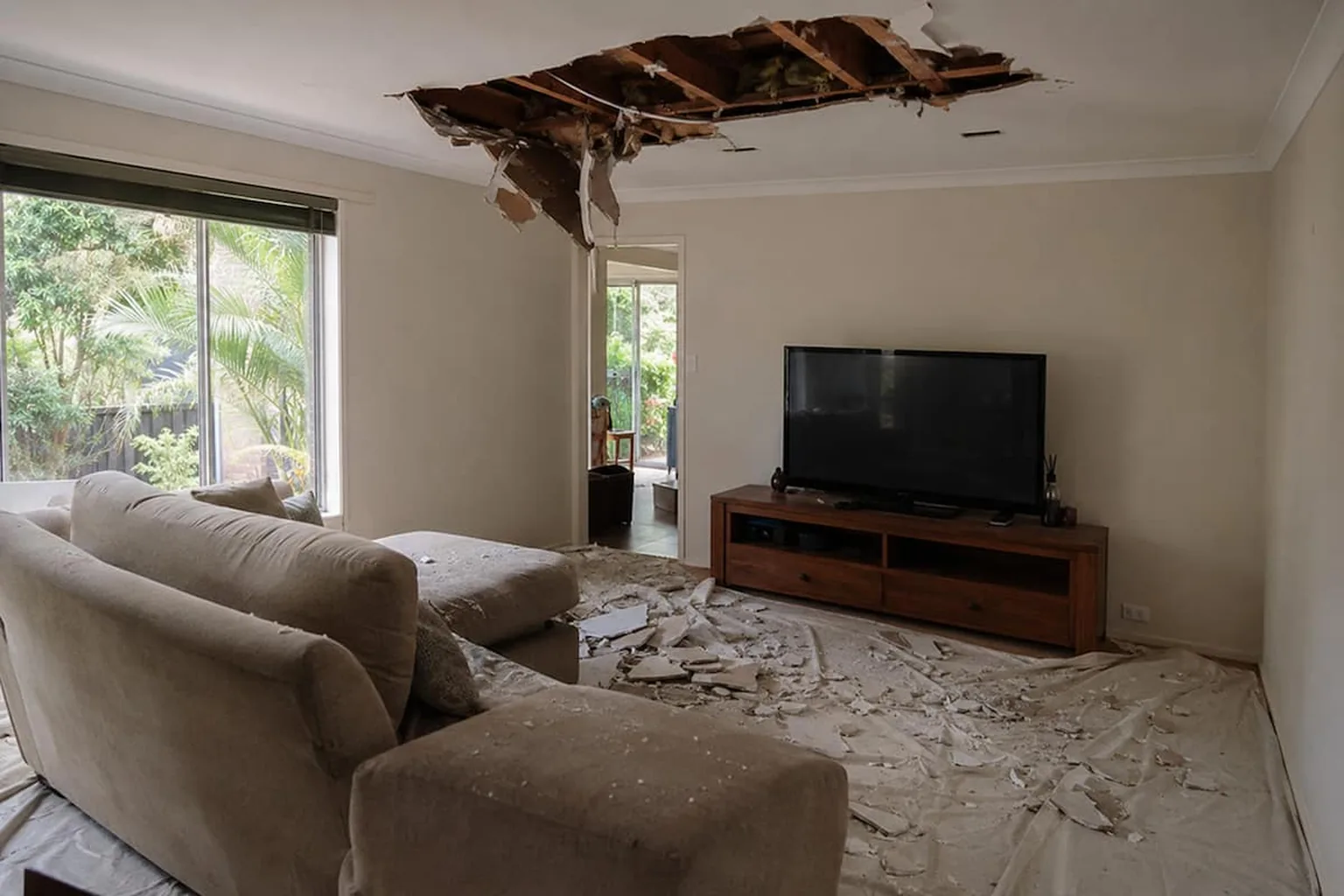 A collapsed ceiling in a Perth living room with the plasterboard down across the floor