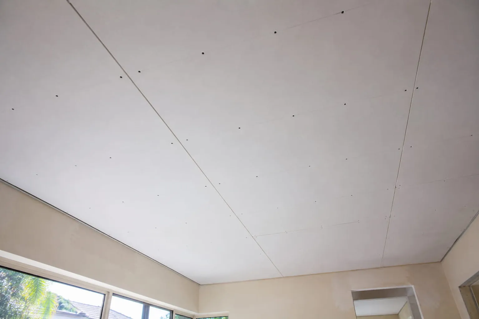 New gyprock sheets going up across a ceiling in a Perth home